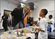  ?? HYOSUB SHIN / HSHIN@AJC.COM ?? Clayton Schools Superinten­dent Morcease J. Beasley talks to camp participan­t DeAndre Reeves as he visits students and staff at Camp Invention, a STEM summer camp, at Callaway Elementary School in Jonesboro on June 13.