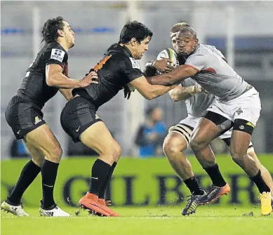  ?? Picture: AFP ?? HOLD UP: Southern Kings wing Makazole Mapimpi, right, is tackled by Argentina’s Jaguares wing Matias Moroni and centre Bautista Ezcurra during their Super Rugby match in Buenos Aires, Argentina. The Kings just pipped pipped their opponents by one point