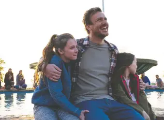  ??  ?? Jason Segel, centre, steps in to help parent Isabella Kai, left, and Violet Mcgraw in the tear-jerker Our Friend.