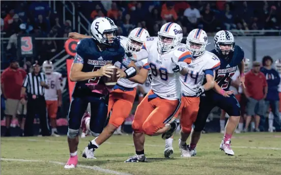  ??  ?? A host of Northwest Whitfield defenders attempt to stop Heritage senior quarterbac­k Corbee Wilson. (File photo/Scott Lane)