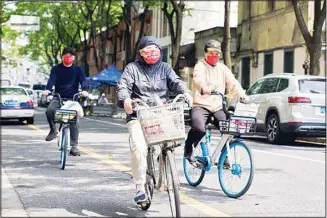  ?? ?? Residents freed from lockdown cycle along a street on Thursday, April 21, 2022, in Shanghai. China’s sluggish economy is reviving as anti-virus curbs are eased and businesses in its commercial capital of Shanghai are allowed to reopen, a Cabinet official said Monday, May 16, while data showed April factory and consumer activity was even weaker than expected. (AP)