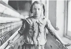  ??  ?? A young spinner in a North Carolina cotton manufactur­ing company poses for Lewis Hine, the documentar­y photograph­er who inspired the creation of laws to ban child labour. — Photo courtesy of Library of Congress