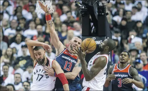  ?? ERNEST DOROSZUK/TORONTO SUN ?? Washington’s Marcin Gortat (second from left) and Bradley Beal (right) had their hands full in Game 1 but they’ll regroup.