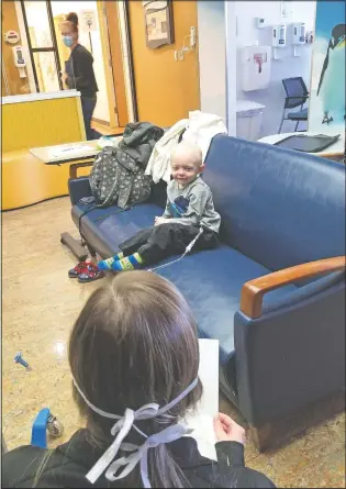  ??  ?? Child Life specialist Jillian Hinko reads an encouragin­g email April 1 written by Sarah to patient Jacen Stout, 2, who’s receiving treatment at the Newark Beth Israel Valerie Fund Center in Newark, N.J.