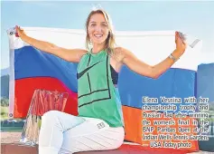  ??  ?? Elena Vesnina with her championsh­ip trophy and Russian flag after winning the women’s final in the BNP Paribas Open at the Indian Wells Tennis Garden. — USA Today photo