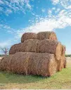  ?? [PHOTO COURTESY OF OKLAHOMA STATE UNIVERSITY] ?? Round bales of hay sit stacked waiting for later use or transport.