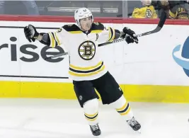  ?? ASSOCIATED PRESS ?? STORMING BACK: Brad Marchand celebrates one of his two goals last night that helped rally the Bruins to a 3-2 victory against the Hurricanes in Raleigh, N.C.