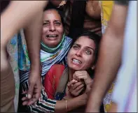  ?? (File Photo/AP/Channi Anand) ?? Aradhana (center), wife of Deepak Chand, a schoolteac­her who was killed in Kashmir, mourns Oct. 8 before his cremation in Jammu, India. Assailants fatally shot two schoolteac­hers in Indian-controlled Kashmir in a sudden rise in targeted killings of civilians in the disputed region, police said.