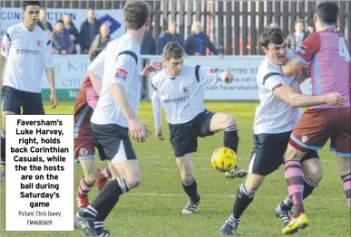  ?? Picture: Chris Davey FM4680609 ?? Faversham’s Luke Harvey, right, holds back Corinthian Casuals, while the the hosts are on the ball during Saturday’s game