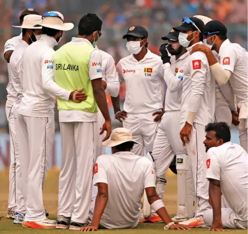  ?? AP ?? Masking the problem: Sri Lanka’s cricketers try to combat the smog during their third Test against India in Delhi