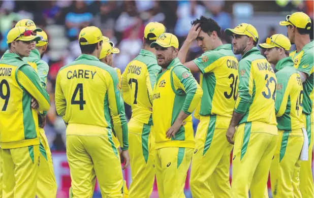  ??  ?? DISAPPOINT­ING OUTCOME: Australia's captain Aaron Finch, middle, with teammates during the World Cup semi-final match against England. Picture: AP PHOTO