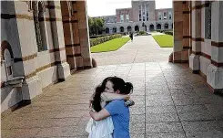  ?? Jon Shapley / Staff photograph­er ?? Alessi Armengol, right, hugged her roommate of three years, Julia Greenberg, on March 12 as Rice University closed its campus due to the pandemic.