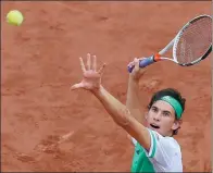  ?? PASCAL ROSSIGNOL / REUTERS ?? Dominic Thiem serves to Novak Djokovic en route to winning their French Open quarterfin­al on Wednesday.