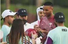  ?? ?? Qatar’s Salem al-Hajri signs autographs during an event with volunteers.