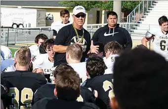  ?? / Tim Godbee, Calhoun City Schools ?? Above: Calhoun head football coach Hal Lamb addresses his players following the 2018 Gold and Black game. Below: Lamb stands with his players and coaching staff on Thursday, after announcing his retirement, when it was shared the field was being dedicated to him as Hal Lamb Field at Phil Reeve Stadium.