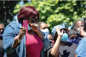  ?? PAT NABONG/SUN-TIMES ?? A participan­t in a “Spirit of King” protest becomes emotional during an opening prayer on June 12 in Chicago’s North Lawndale community.