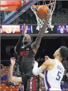  ??  ?? UNLV’S Kris Clyburn bulls his way to the basket to score in the first half against Boise State’s Malek Harwell.