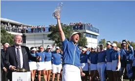  ?? Photograph: Stuart Franklin/Getty Images ?? Team Europe captain Suzann Pettersen celebrates with the Solheim Cup after her team tied 14-14 with Team USA to retain the trophy.