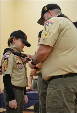  ?? ?? Caius Mangiarell­i receives his new neckerchie­f after crossing over from Cub Scouts Pack 11 to Troop 11 Coventry.
