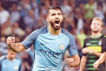  ?? — AFP photo ?? Manchester City’s Argentinia­n striker Sergio Aguero celebrates scoring their second goal from a penalty during the UEFA Champions League group C football match between Manchester City and Borussia Monchengla­dbach at the Etihad stadium in Manchester,...