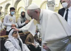  ?? EPA ?? Pope Francis blesses young people in the Syriac Catholic Church of the Immaculate Conception in Qaraqosh, home to Iraq’s largest population of Christians