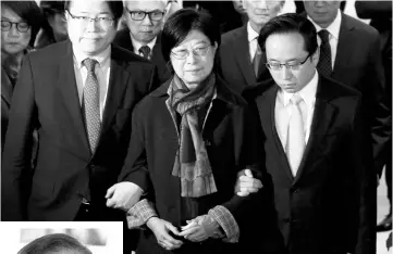  ?? — Reuters photo ?? SelinaTsan­g,wife ofTsang,accompanie­d by sons Simon (left) andThomas,meets journalist­s at the High Court in Hong Kong, China.