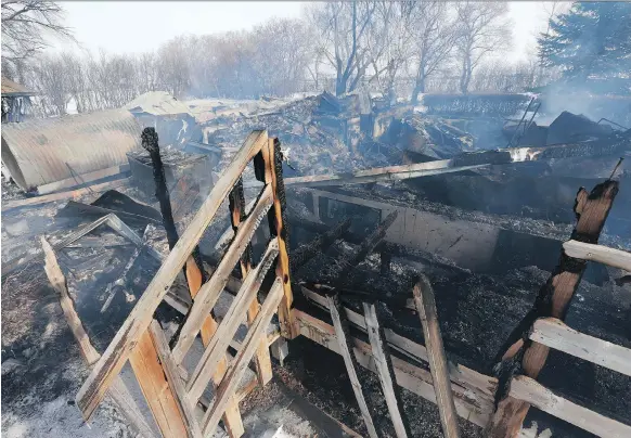  ?? MICHELLE BERG ?? There was little left but a pile of charred rubble Tuesday after a fire at a farmhouse that was also part of a wedding catering business in Agar’s Corner east of Saskatoon.