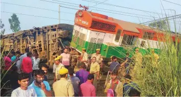  ?? PTI ?? Police and locals at the site of the accident where eight coaches and the engine of the New Farakka Express train derailed near Rae Bareli, yesterday.