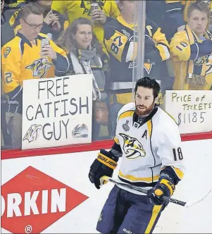  ?? AP PHOTO ?? Nashville Predators’ James Neal skates past Predators fans holding signs as he warms up for Game 2 of the team’s NHL Stanley Cup Final against the Pittsburgh Penguins on May 31.