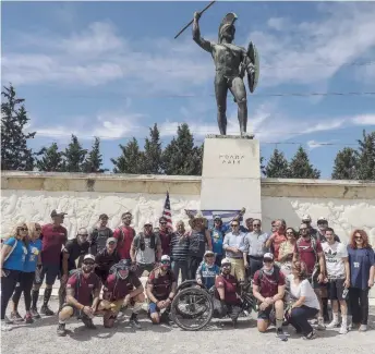  ??  ?? The team poses for a photograph at the statue of Leonidas in Sparta.