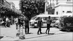  ??  ?? Police officers are seen at the site of an explosion in downtown Tunis. (Photo: Malay Mail)