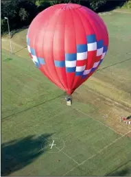  ??  ?? Arkansas Democrat-Gazette/RYAN McGEENEY
Allen Lawson of Branson attempts to strike a ground target with a beanbag Saturday morning during the 18th annual Arkansas Hot Air Balloon Festival in Harrison.