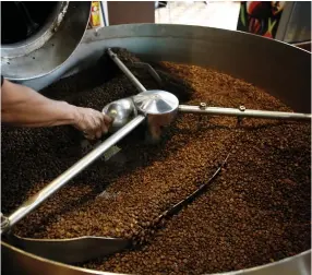  ?? (Reuters) ?? A MAN ROASTS coffee in San Jose, Costa Rica.