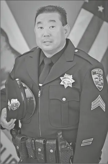  ?? BRANDON VACCARO/AP ?? This undated photo provided by the Town of Colma Police Department, in California, shows former Officer Kevin Nishita. Nishita, a retired police officer and armed guard who provided security for many reporters in the region, was shot in the abdomen during an attempted robbery of KRON-TV’s camera equipment in Oakland, Calif., on Wednesday. The news crew was covering a recent smashand-grab robbery of a clothing store. Parts of California have been struck by a rash of organized retail thefts in which bands of thieves break into high-end stores and snatch merchandis­e.