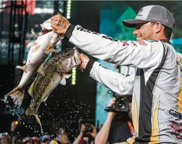  ?? Brett Coomer / Houston Chronicle ?? Jordan Lee, who won the 2017 Bassmaster Classic held on Lake Conroe, displays two of the five largemouth bass — totaling 27 pounds, 4 ounces — he caught off a submerged point in 5-6 feet of water on the final day of the profession­al bass fishing...