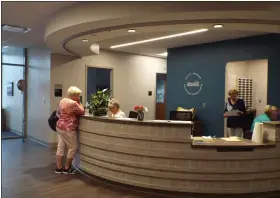  ?? THE NEWS-HERALD FILE ?? Seniors visit the front desk of Willoughby’s new David E. Anderson Senior Center on Aug. 13.