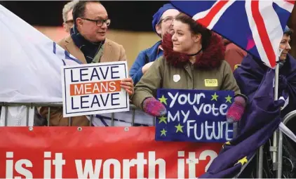  ?? - AFP ?? DEEPLY DIVIDED: A pro-Brexit protester, interacts with a supporter of a second EU referendum, right, outside the Houses of Parliament in central London on January 15, 2019.
