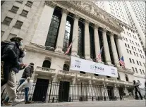  ?? JOHN MINCHILLO — THE ASSOCIATED PRESS FILE ?? In this Jan. 27, 2021file photo, pedestrian­s pass the New York Stock Exchange in New York. Stocks were solidly lower in early trading Tuesday, May 4, dragged down by banks and big technology companies like Apple and Google.