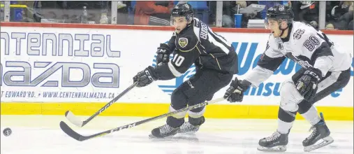  ?? JASON MALLOY/THE GUARDIAN ?? Charlottet­own Islanders Brett Budgell, left, fires a shot toward the Blainville-Boisbriand Armada goal while being defended by Samuel Bolduc Tuesday during Game 3 of the Quebec Major Junior Hockey League semifinal.