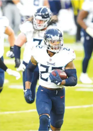  ?? AP PHOTO/ NICK WASS ?? Tennessee Titans running back Derrick Henry heads to the end zone for the winning touchdown in a 34-21 overtime victory Sunday against the host Baltimore Ravens.