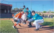  ??  ?? Devin Lopez and his Little League team get to meet the Fuego players and take the field with them for the national anthem before the start of a game at Fort Marcy Field on June 9.