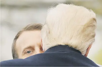  ?? Picture: Reuters ?? COAXING AND CAJOLING. US President Donald Trump and French President Emmanuel Macron hug during an arrival ceremony at the White House in Washington on Tuesday.