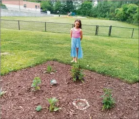  ?? Emily M. Olson / Hearst Connecticu­t Media ?? Karen Mangine and Erin French, kindergart­en teachers at the Torringfor­d School have created a pollinator garden and hope to continue the project to include an outdoor classroom space and a trail. Above is French’s daughter, Elle.