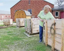  ?? [PHOTOS BY SHARLA BARDIN, FOR THE OKLAHOMAN] ?? Cathe Fox checks out the soil in some of the raised beds that are included in a new community garden in Norman. The beds offer easier access for people with physical disabiliti­es or those with mobility challenges.