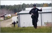  ?? ROBERT F. BUKATY — THE ASSOCIATED PRESS FILE ?? A police officer gives an order to the public during a manhunt at a farm in Lisbon, Maine, on Oct. 27followin­g two mass shootings.