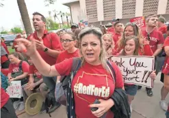  ?? DAVID WALLACE/THE REPUBLIC ?? Aurelia Ionescu, a first-grade teacher at Balsz Elementary School, cheers following a press conference at the state Capitol.