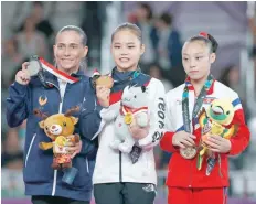  ?? — Reuters ?? Silver medallist Oksana Chusovitin­a of Uzbekistan, gold medallist Yeo Seo-jeong of South Korea and bronze medallist Pyon Rye Yong of North Korea celebrate on the podium.