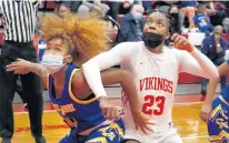  ?? JOHN SMIERCIAK/DAILY SOUTHTOWN ?? Crete-Monee’s Micah Lear, left, and Homewood-Flossmoor’s Alyssa Latham fight for a rebound during Monday’s game.