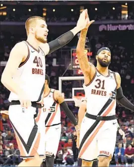  ?? Jason Miller Getty Images ?? IVICA ZUBAC (40) and Marcus Morris, wearing throwback Buffalo Braves jerseys in February, are among three Clippers yet to join the team at practice.