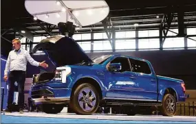  ?? Antonio Perez / Tribune News Service ?? The highly anticipate­d Ford F-150 Lightning on display in Chicago in 2021. Ford has told its dealers they have until Friday to decide whether to invest between $500,000 and $1.2 million to continue selling the company’s electric vehicles beyond 2023.